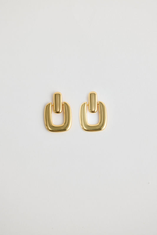 Close-up of gold avery earrings earrings on white background.