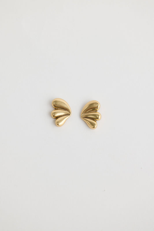Close-up of gold taylor earrings earrings on white background.