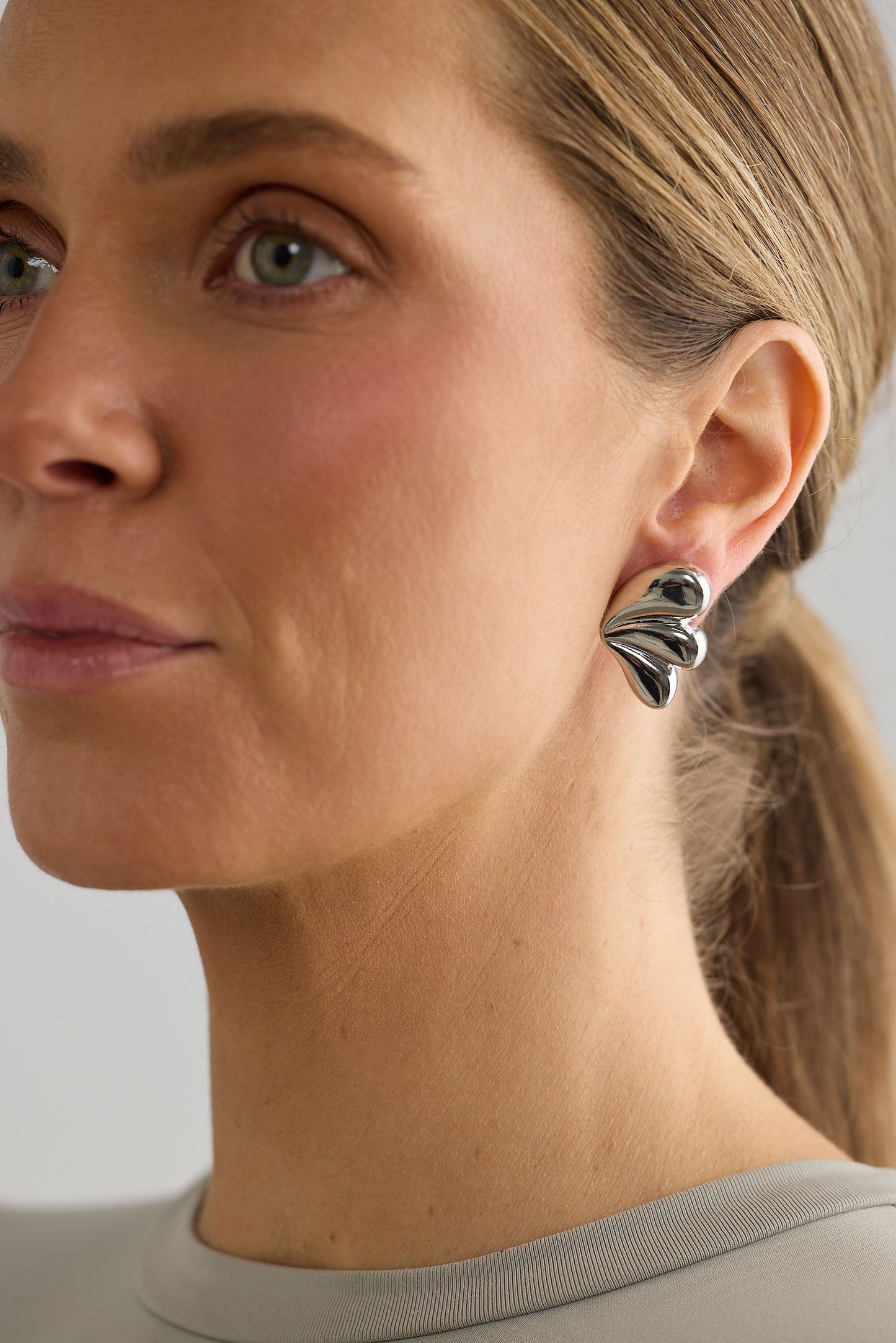 Close-up of silver taylor earrings earrings on white background.