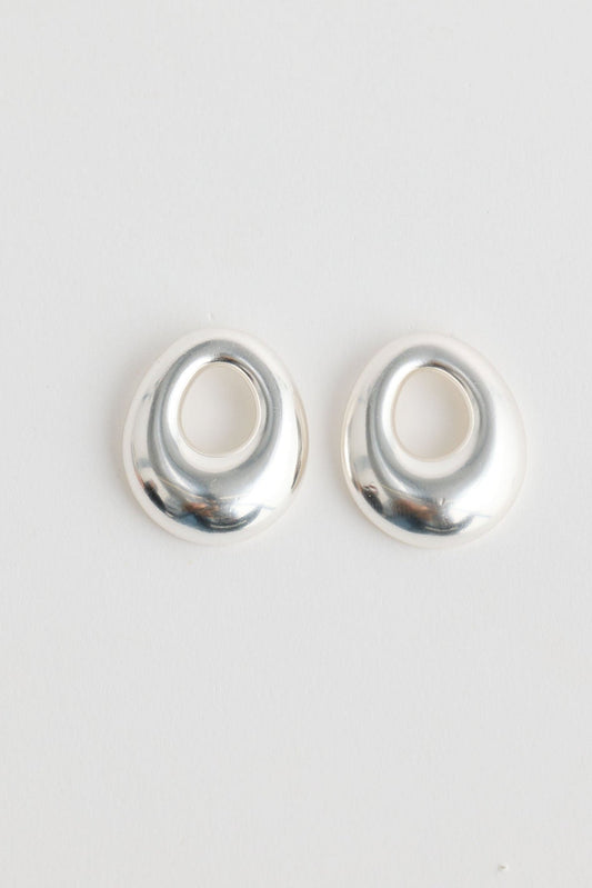 Close-up of silver jordan earrings earrings on white background.