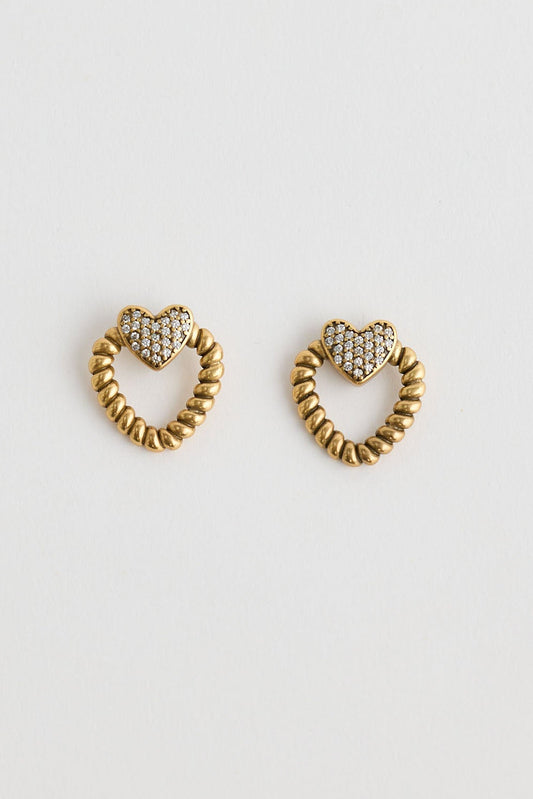 Close-up of gold charlie earrings earrings on white background.