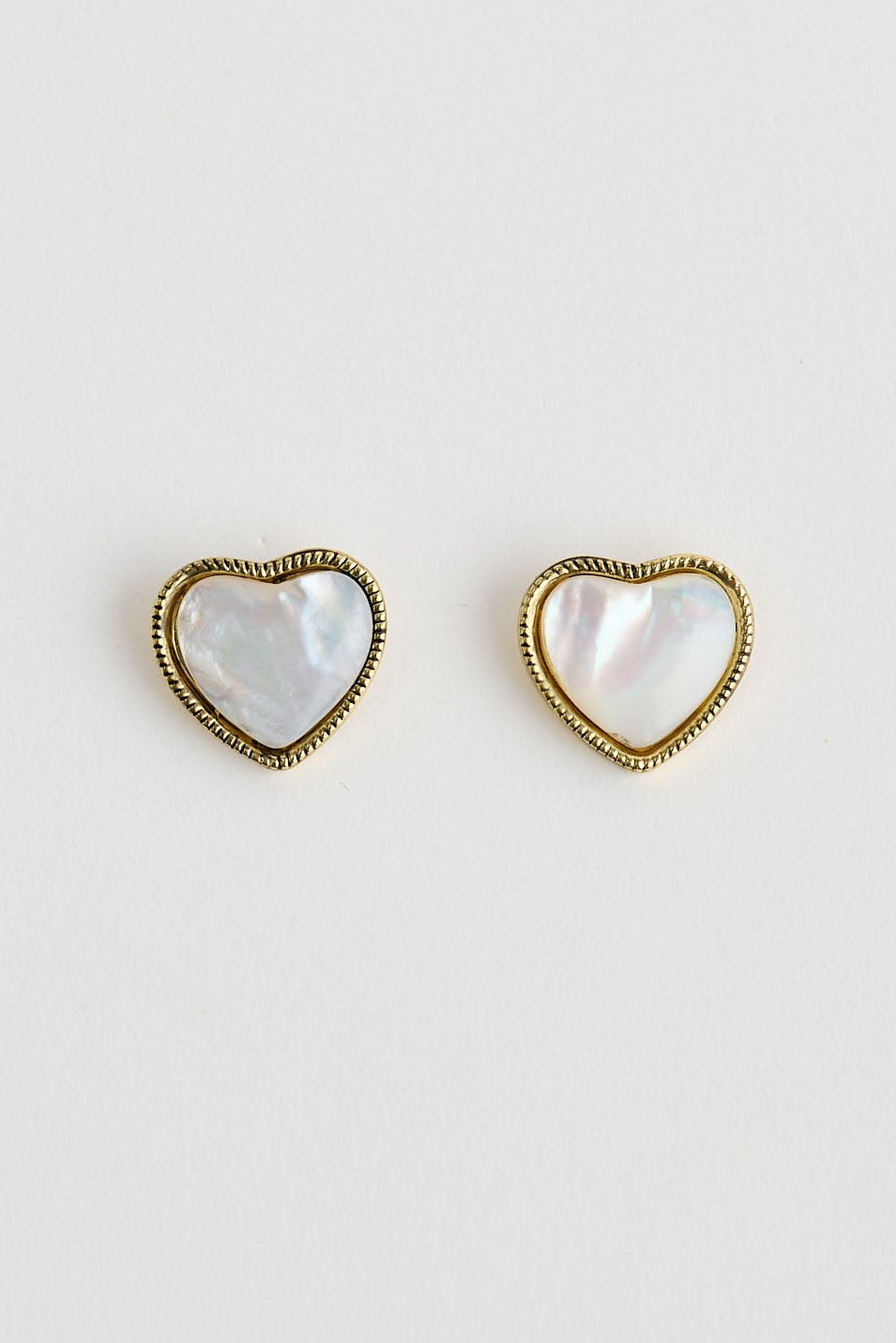 Close-up of white finley earrings earrings on white background.