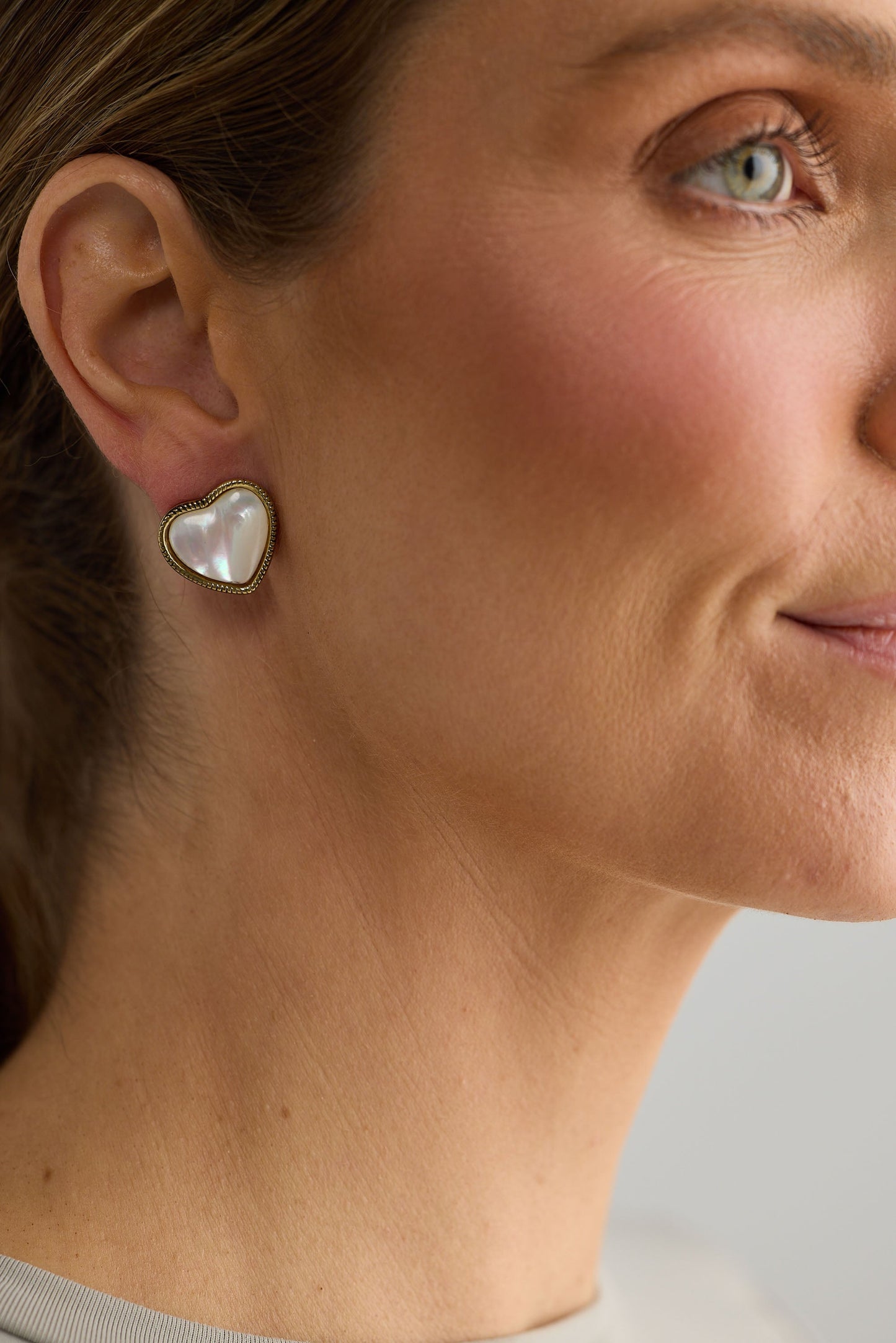 Close-up of white finley earrings earrings on white background.