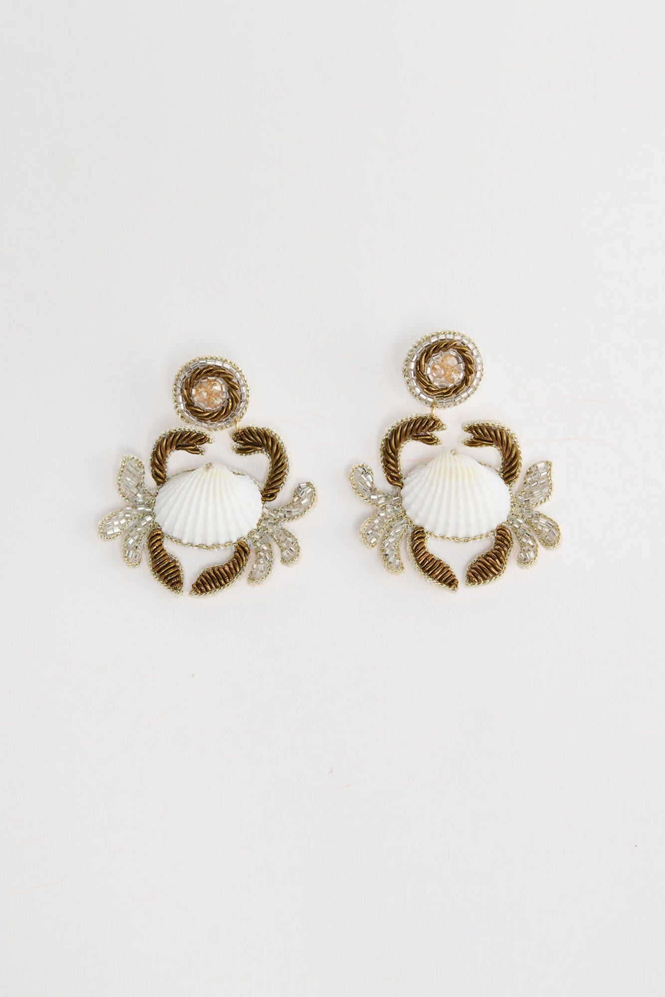 Crabby Earrings in white – pair of beaded crab statement earrings with white shell centres laid flat