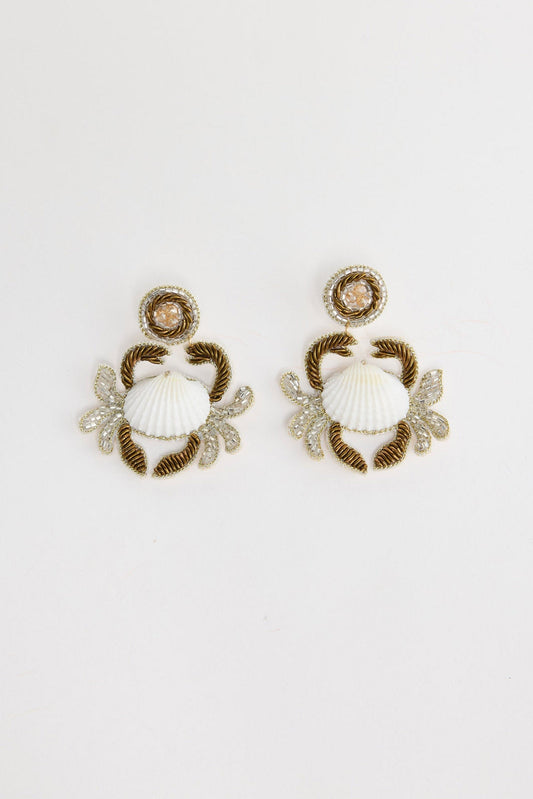 Crabby Earrings in white – pair of beaded crab statement earrings with white shell centres laid flat