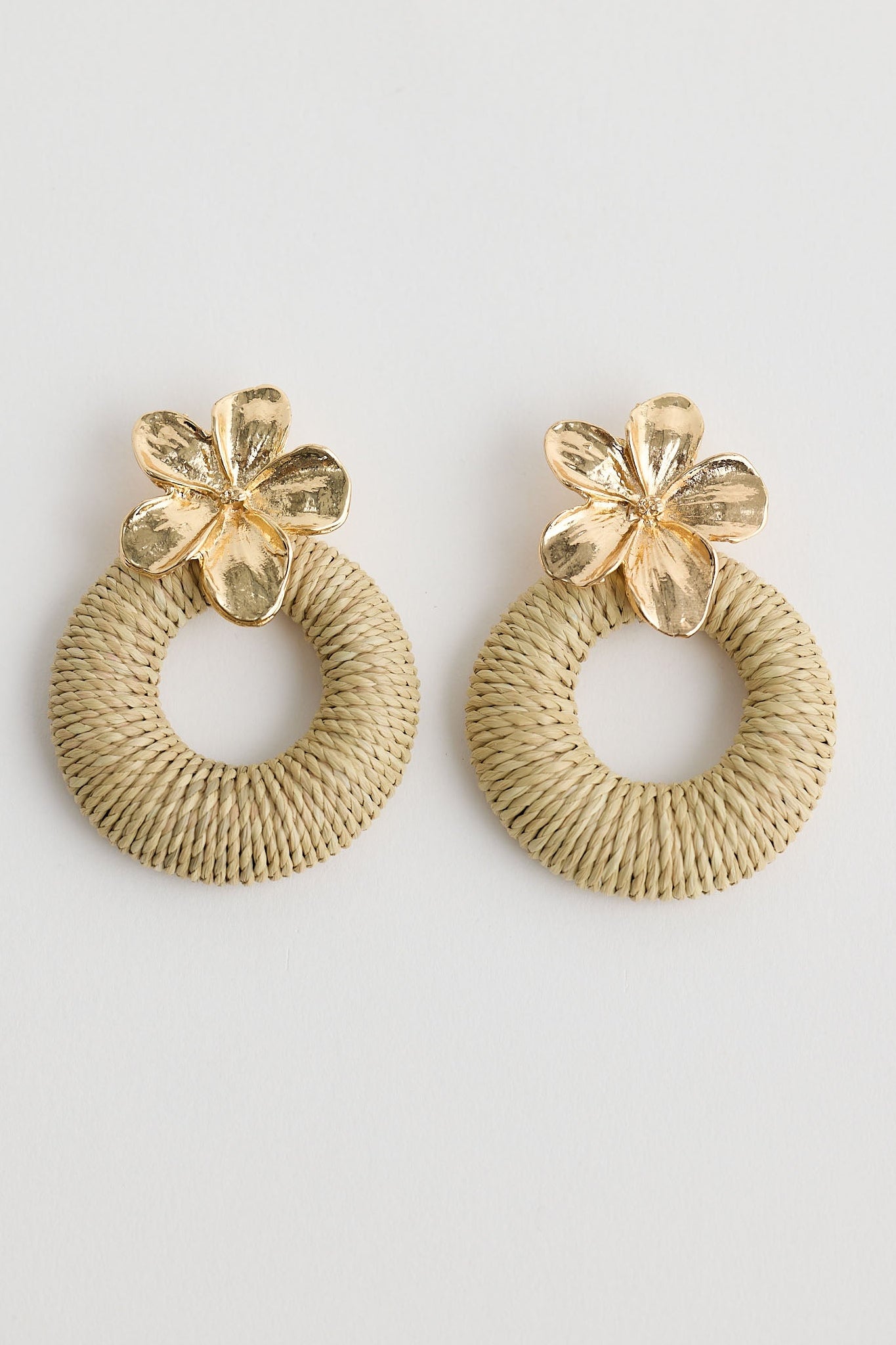 Close-up of natural frangipani earrings earrings on white background.