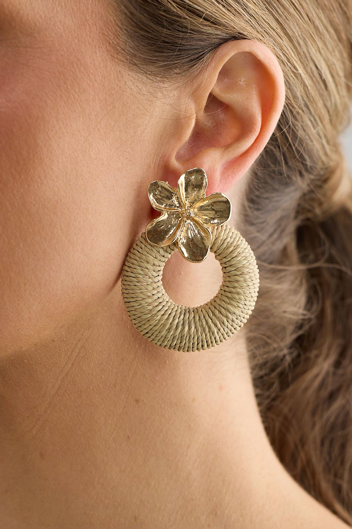 Close-up of natural frangipani earrings earrings on white background.