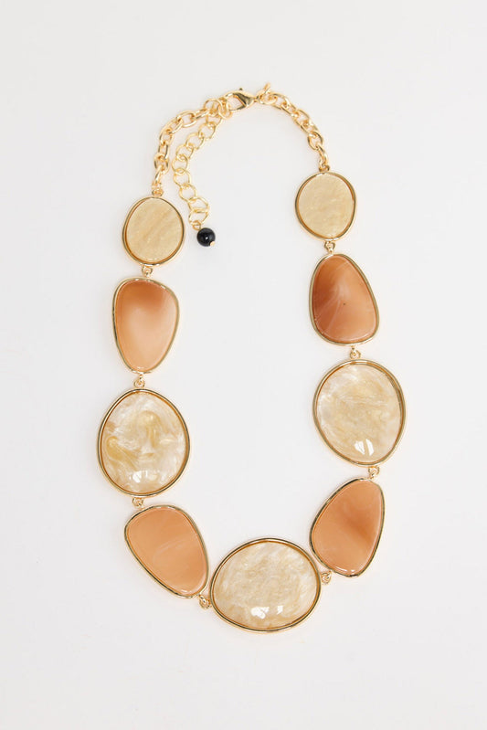 Ariel Necklace in salmon with white – flat lay of gold-tone chain with alternating salmon and cream resin-look oval links