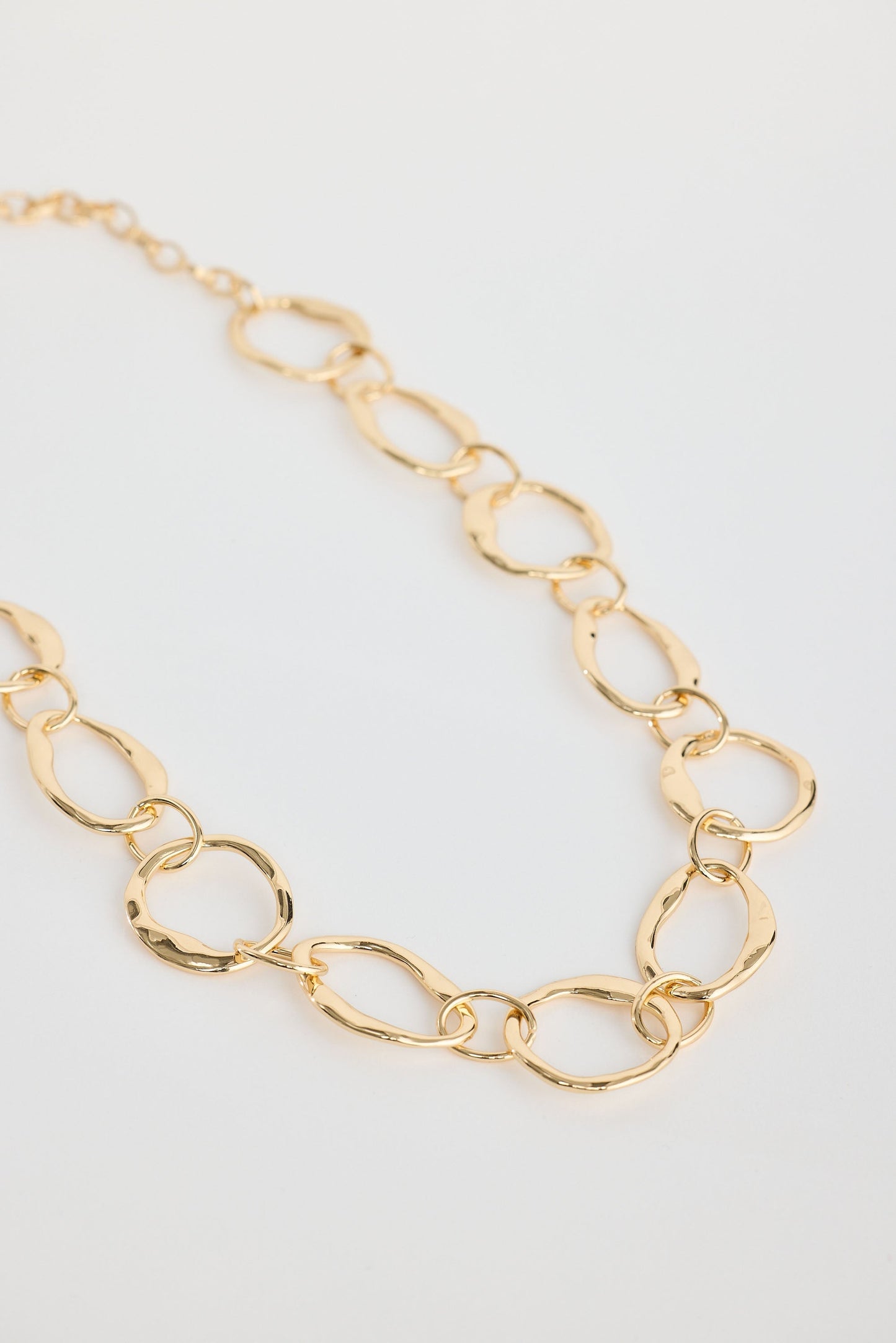 Close-up of gold hemsworth necklace necklace on white background.