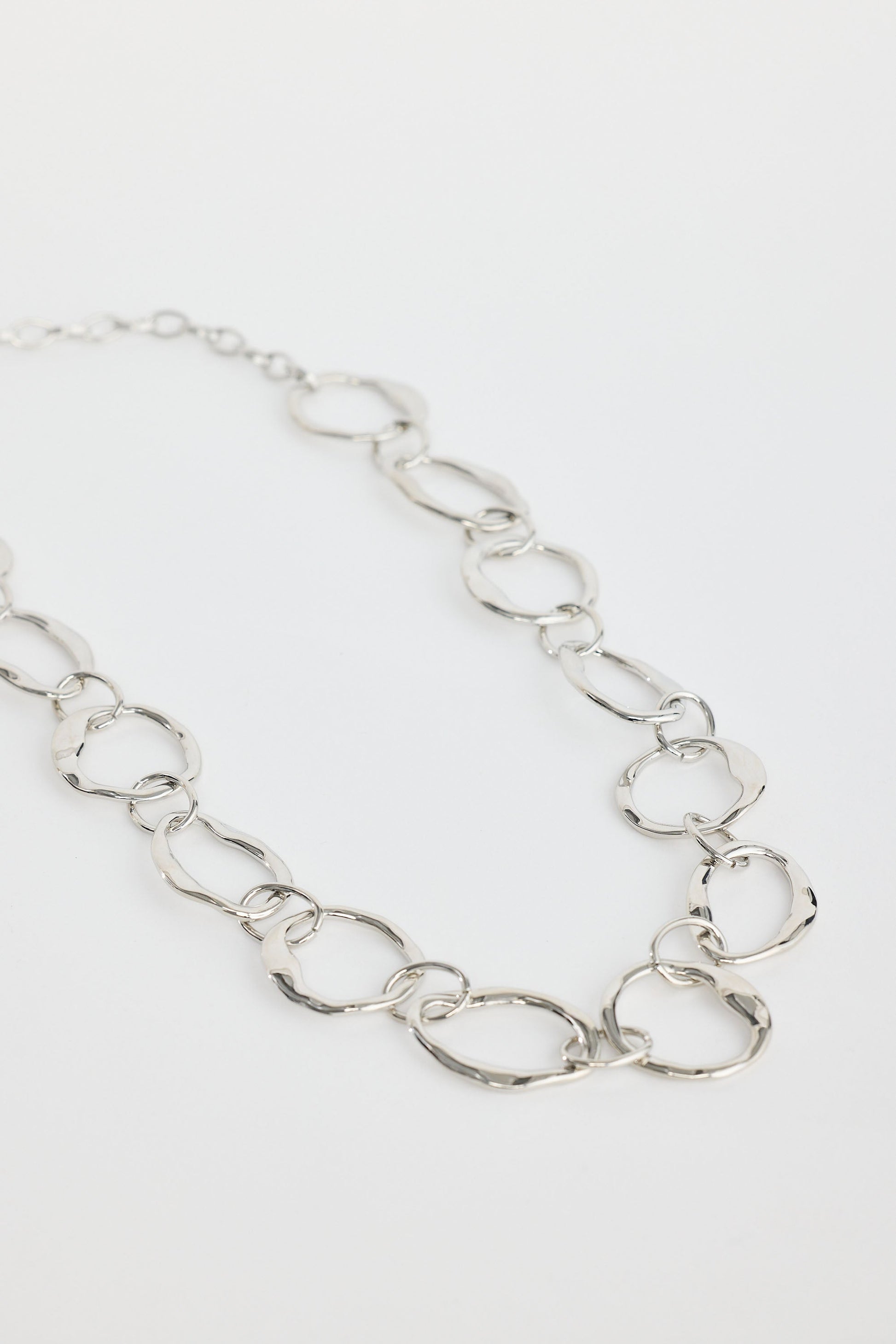 Close-up of silver hemsworth necklace necklace on white background.
