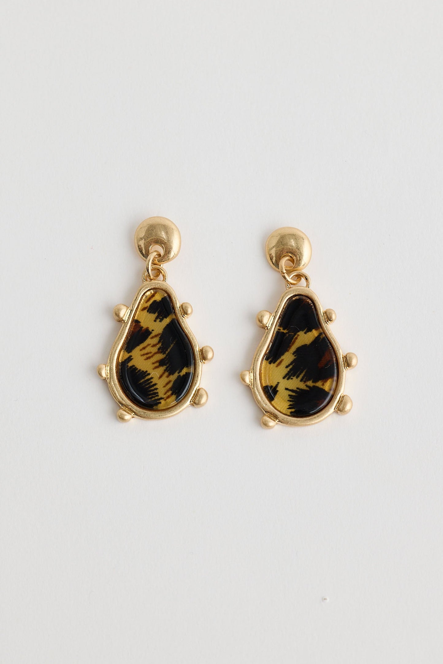 Pair of earrings with black and gold design on a white background