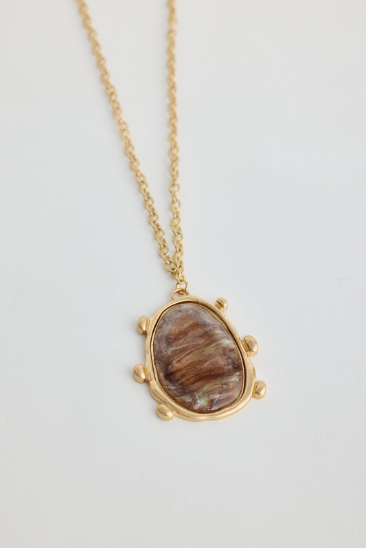 Necklace with a stone pendant on a light gray background