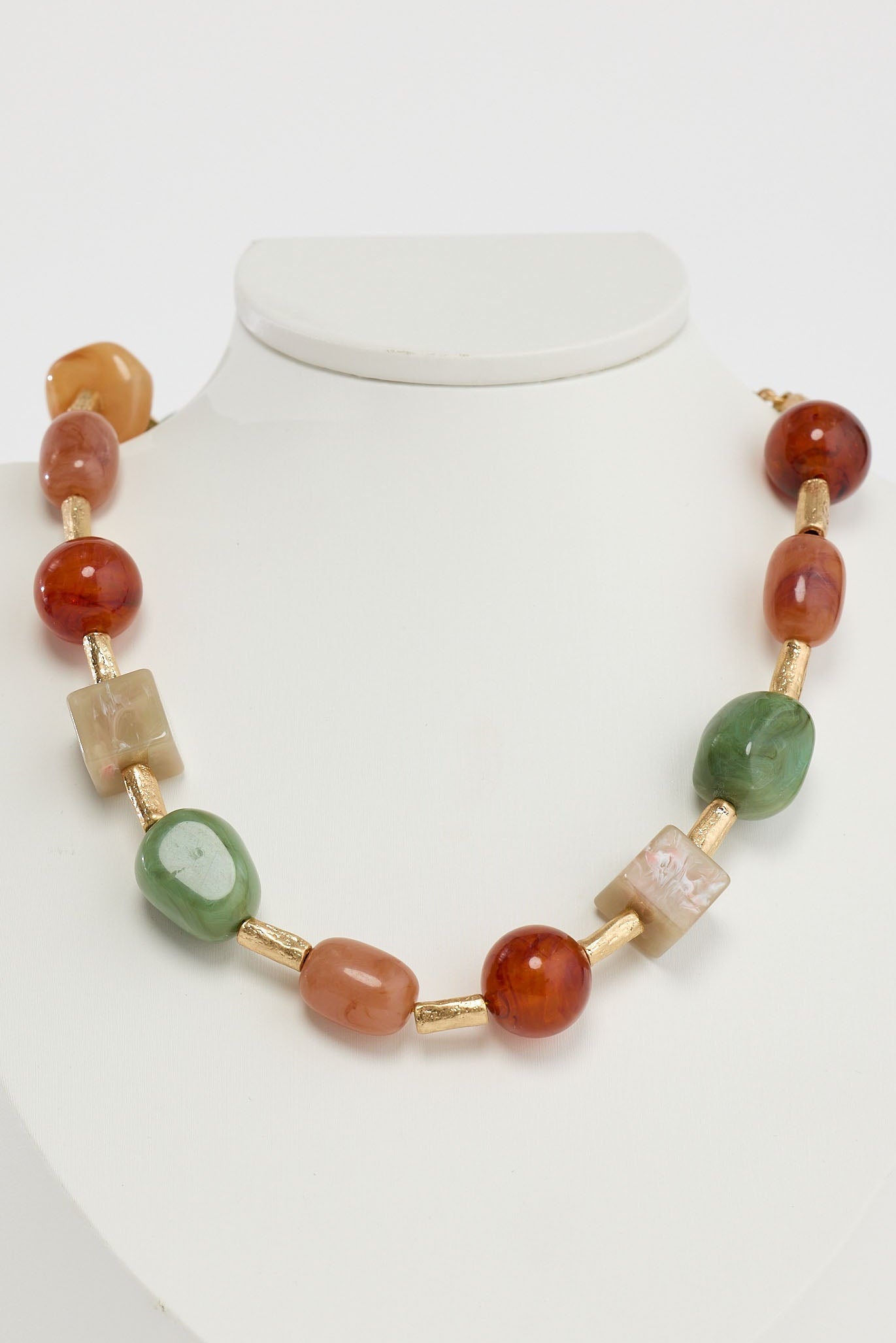 Close-up of sage autumn necklace necklace on white background.