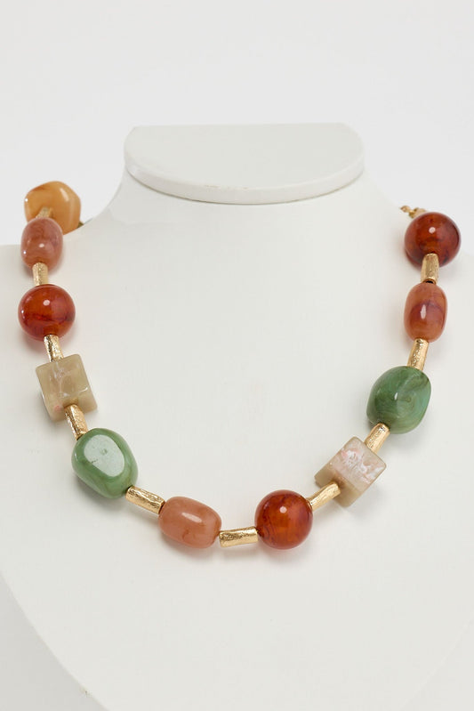 Close-up of sage autumn necklace necklace on white background.