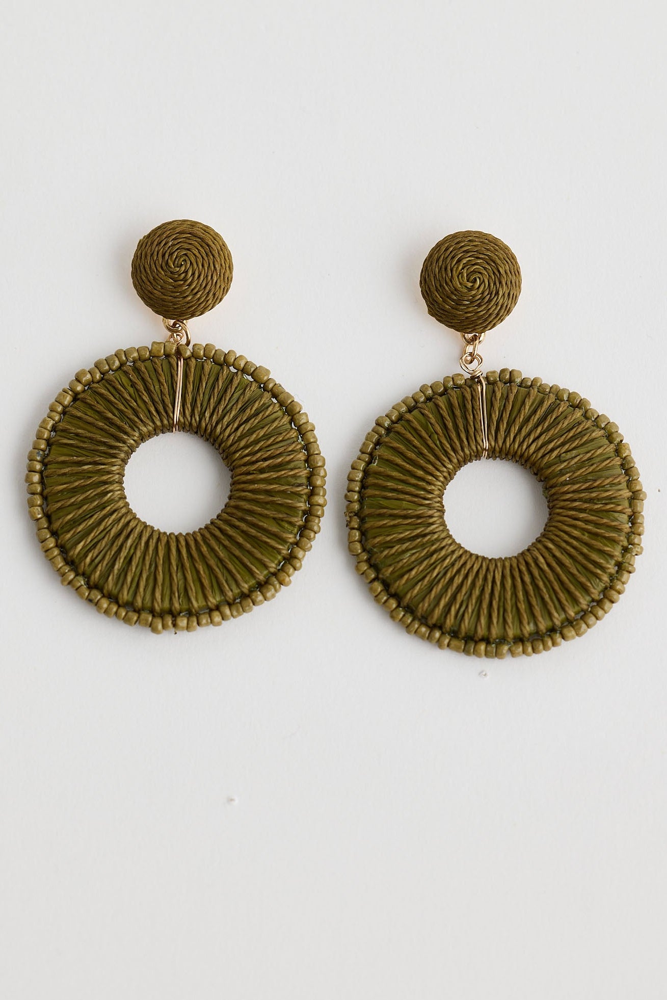 Pair of green hoop earrings on a white background