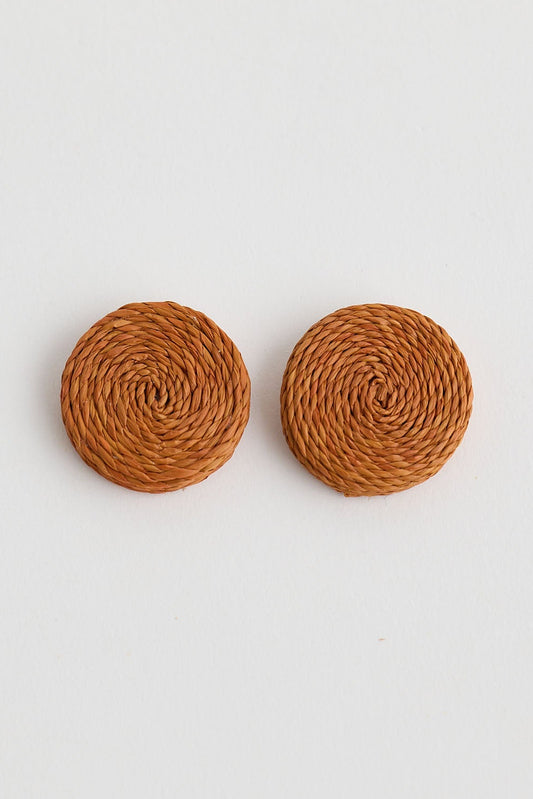 Pair of round brown earrings on a light gray background