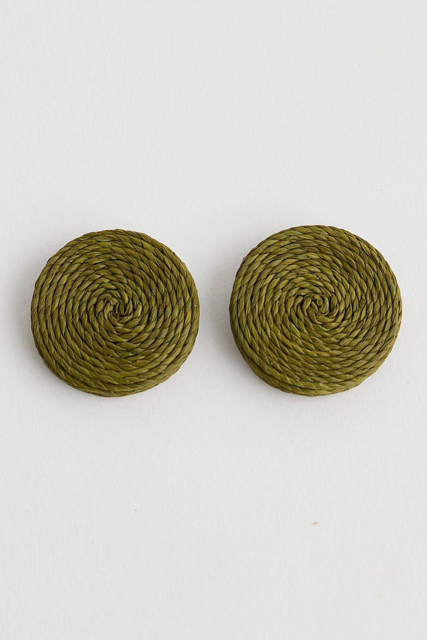 Pair of round green earrings on a white background