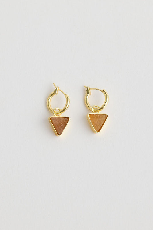 Close-up of cocoa parton earrings earrings on white background.