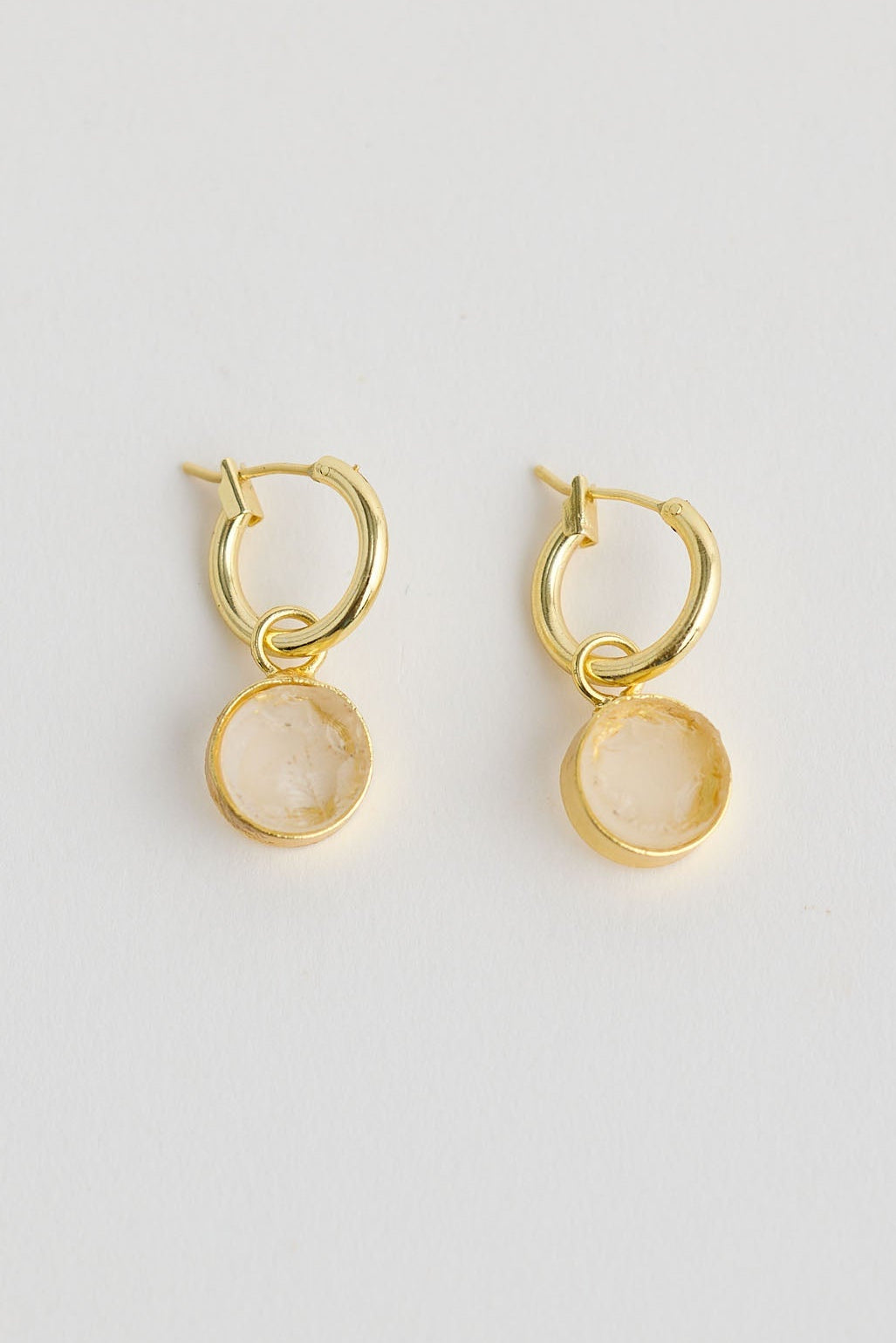 Close-up of amber carey earrings earrings on white background.