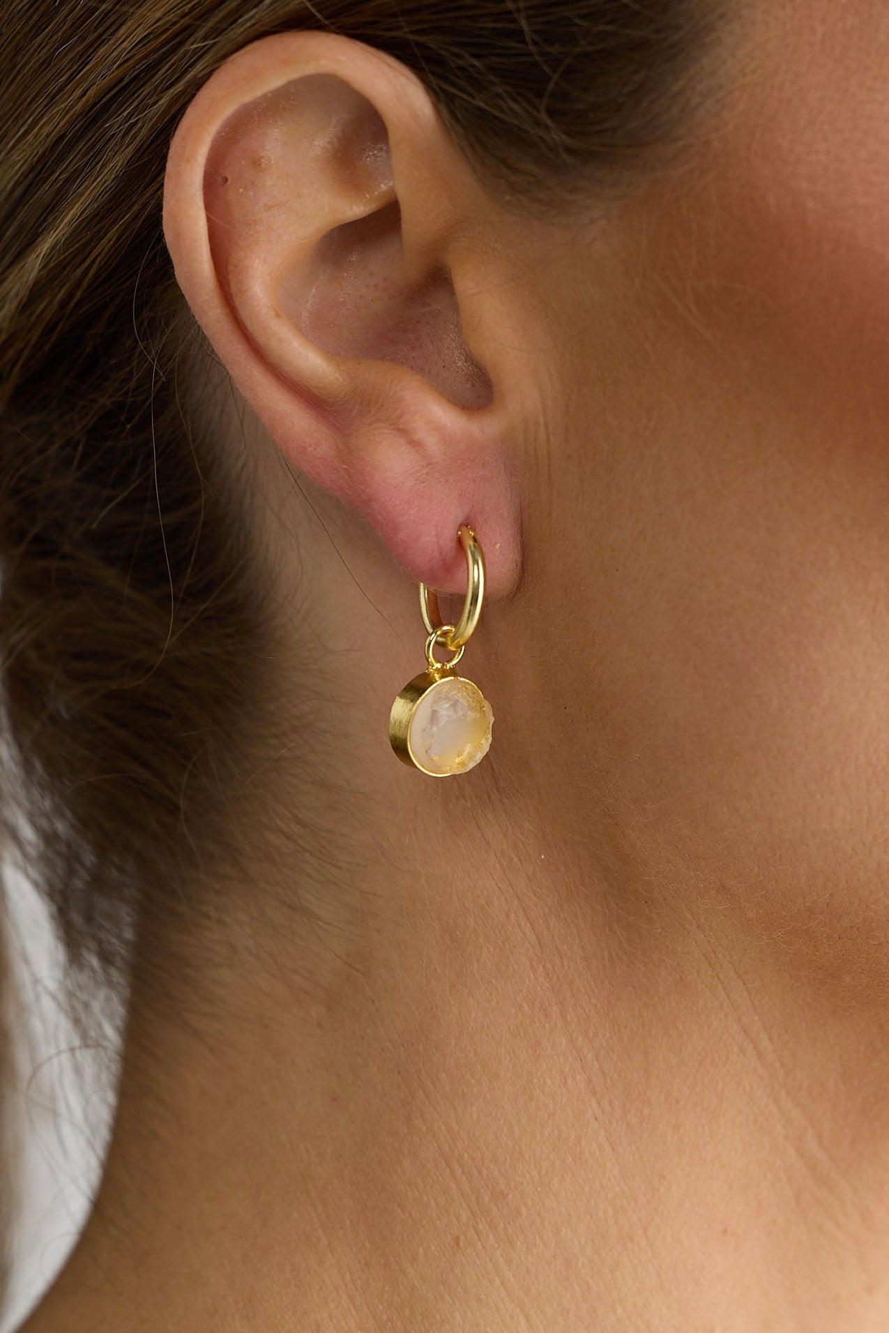 Close-up of amber carey earrings earrings on white background.