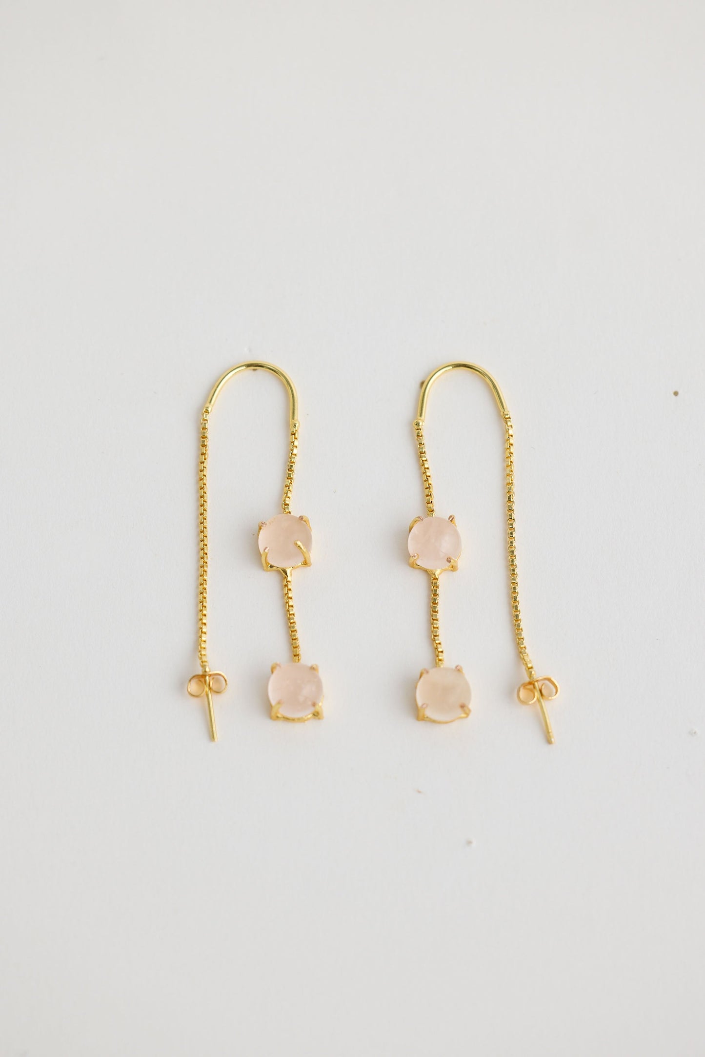 Close-up of white houston earrings earrings on white background.