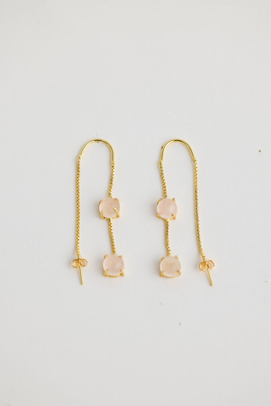 Close-up of white houston earrings earrings on white background.