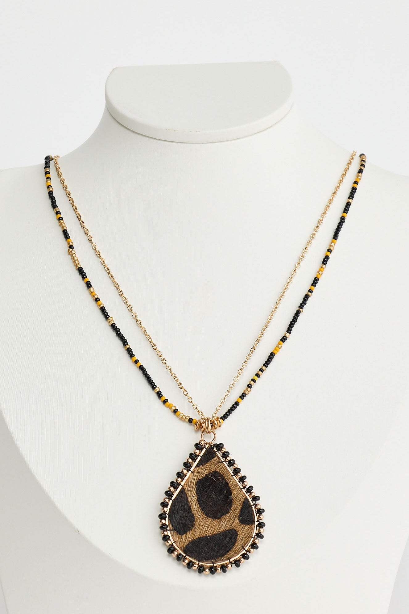 Necklace with a teardrop-shaped pendant on a mannequin against a white background
