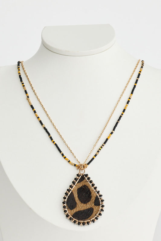 Necklace with a teardrop-shaped pendant on a mannequin against a white background