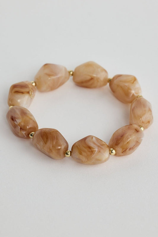 Close-up of sand marble havana bracelet bracelet on white background.