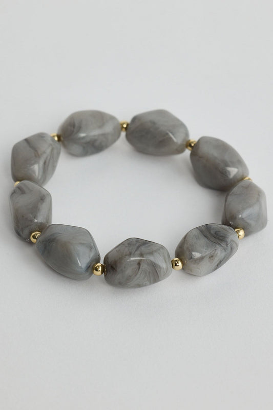 Close-up of slate havana bracelet bracelet on white background.