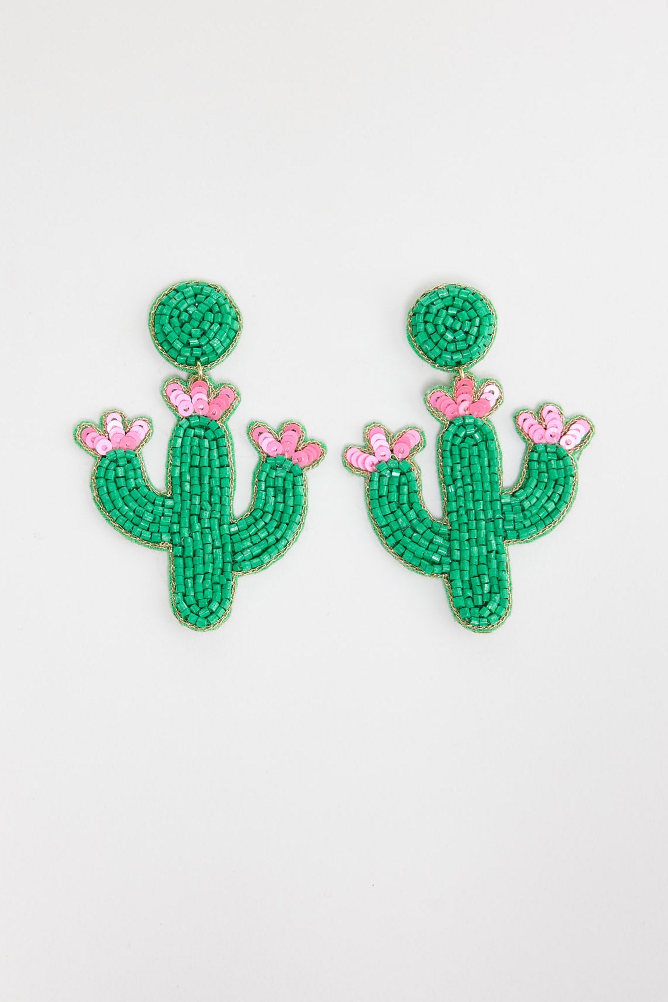 Pair of large beaded cactus statement drop earrings in bright green seed beads with pink sequin flower blooms at the tips, on a round green beaded stud, laid flat on a white background