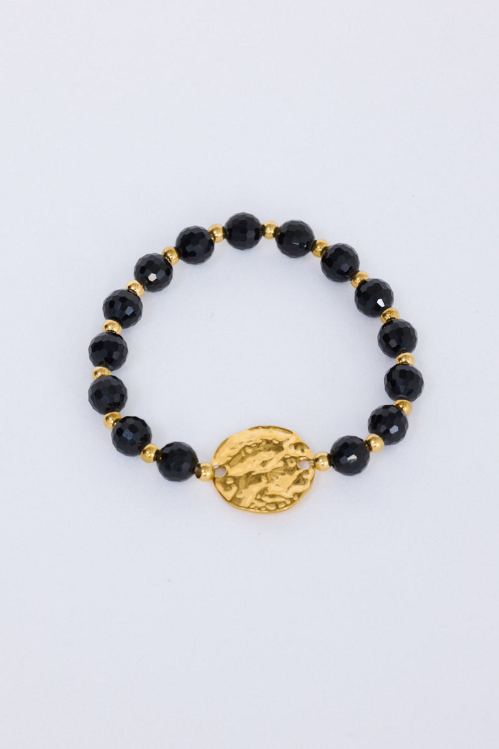 Taylor Bracelet in black with statement gold charm detail, front view on white background