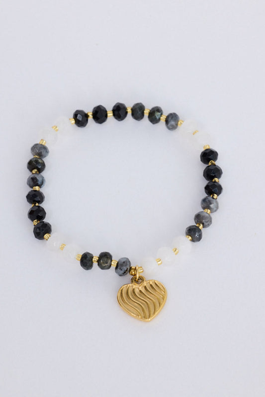 Huda Bracelet in black with statement gold charm detail, front view on white background