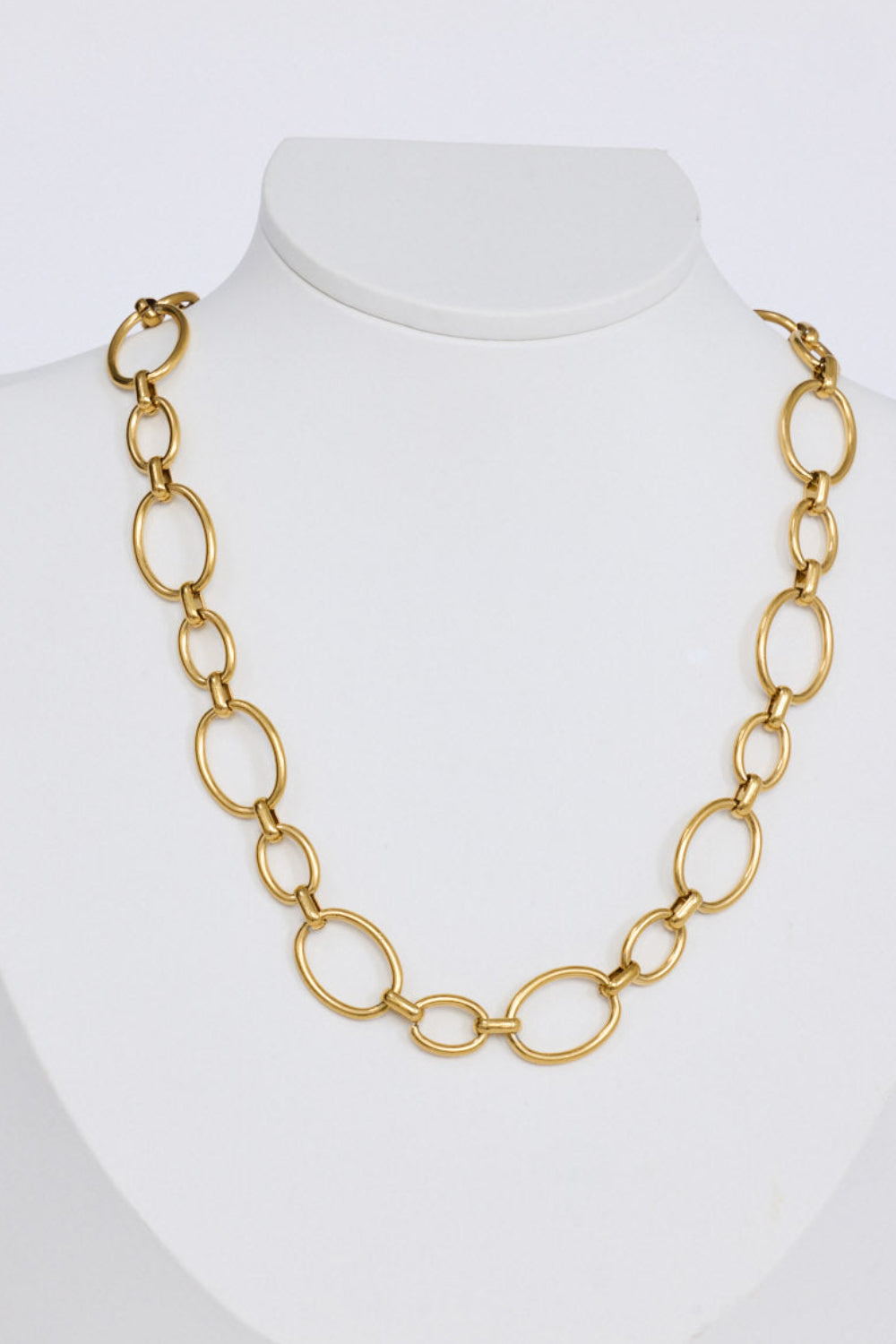 Lexi Necklace in gold with bold rounded link detailing, angled view on white background