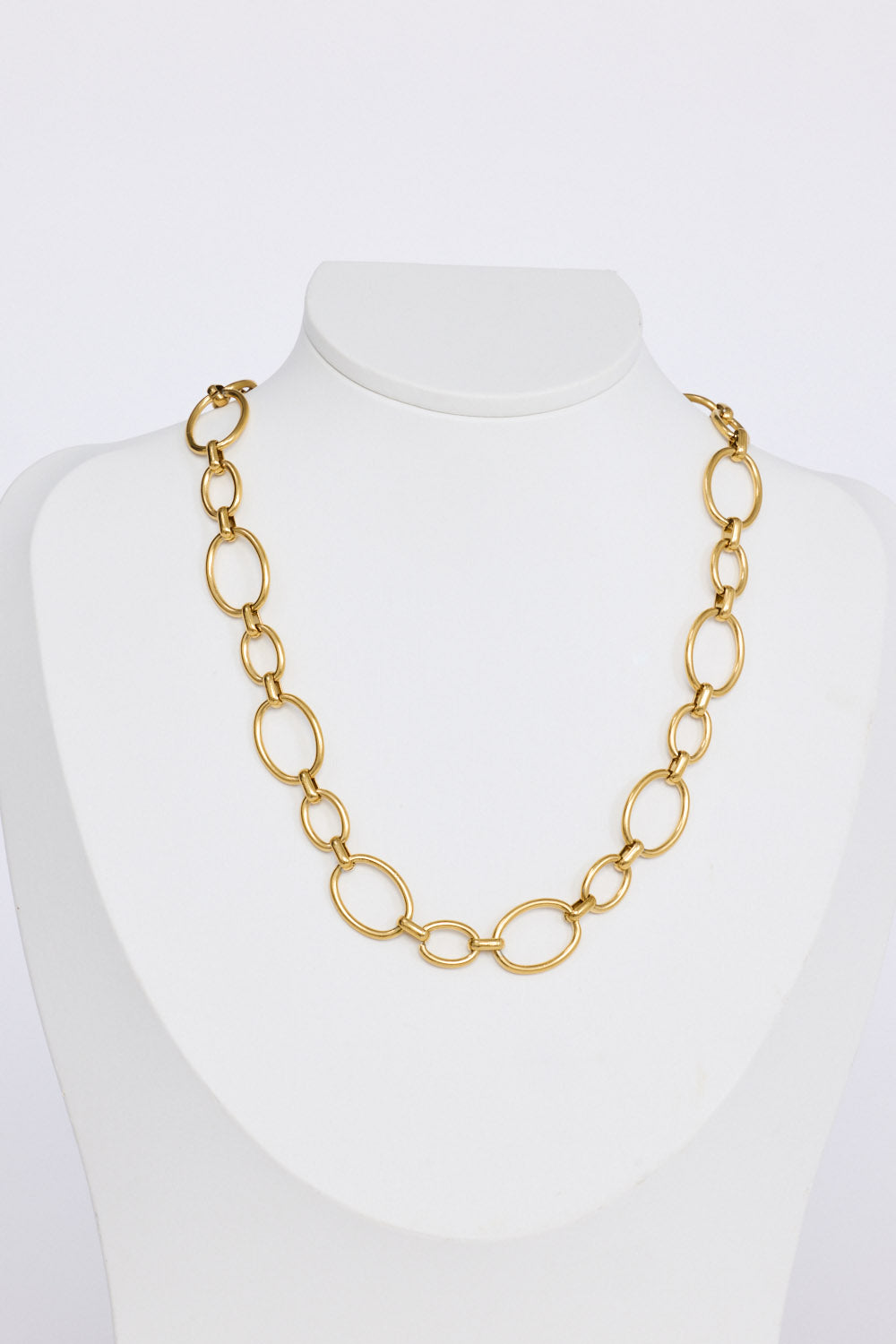 Lexi Necklace in gold with bold rounded link detailing, pendant close-up view on neutral background