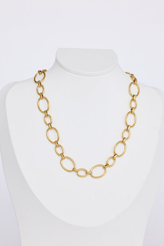 Lexi Necklace in gold with bold rounded link detailing, pendant close-up view on neutral background