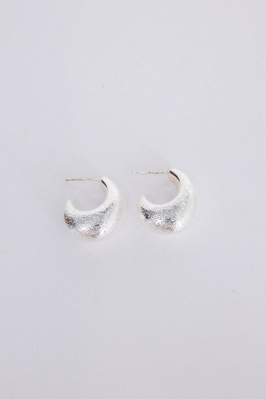 Grace Earrings in silver with a textured finish, angled view on white background