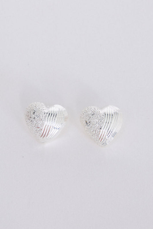 Gabby Earrings in silver with fine textured detailing, angled view on white background