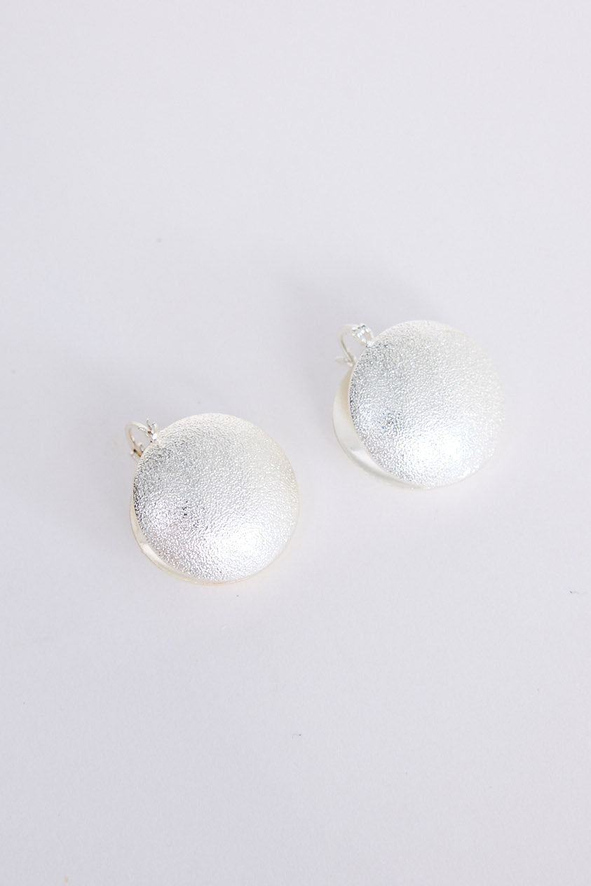 Sue Earrings in silver with a brushed textured finish, front view on white background