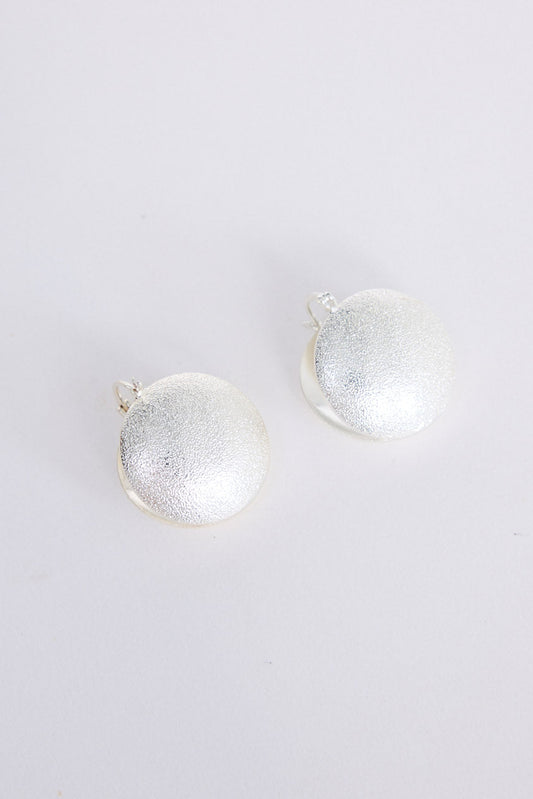 Sue Earrings in silver with a brushed textured finish, front view on white background