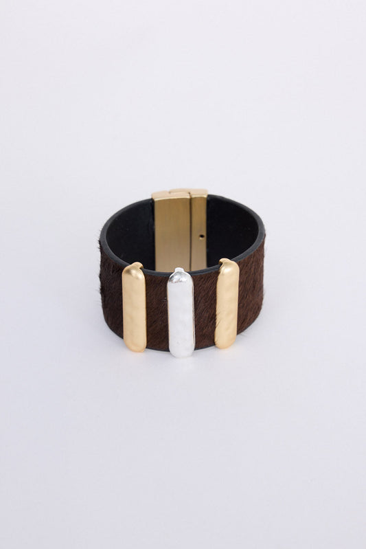 Anima Cuff in tan with bold metal bar detailing, front view on white background