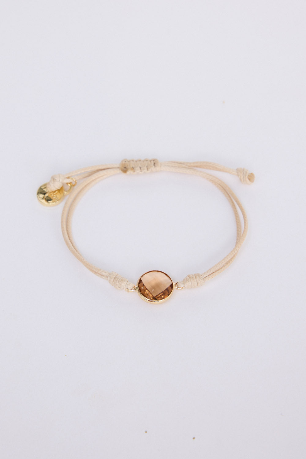 Hamilton Bracelet in beige with central stone feature, angled view on white background