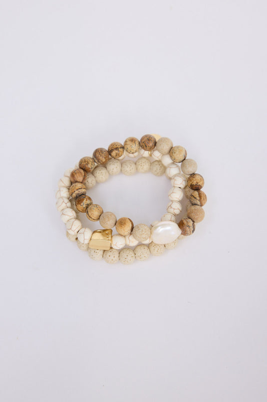 Solaro Stack Bracelet in natural with natural stones and mother of pearl feature bead, angled view on white background