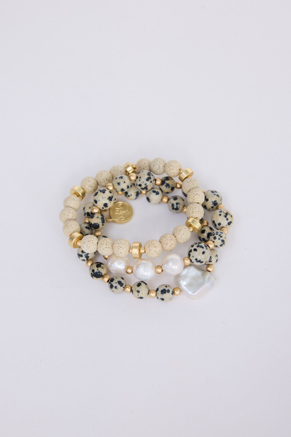 Kendra Stack Bracelet in grey with natural stones and mother of pearl feature bead, flat lay detail view on white background