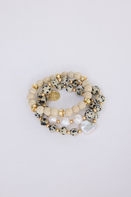 Kendra Stack Bracelet in grey with natural stones and mother of pearl feature bead, flat lay detail view on white background