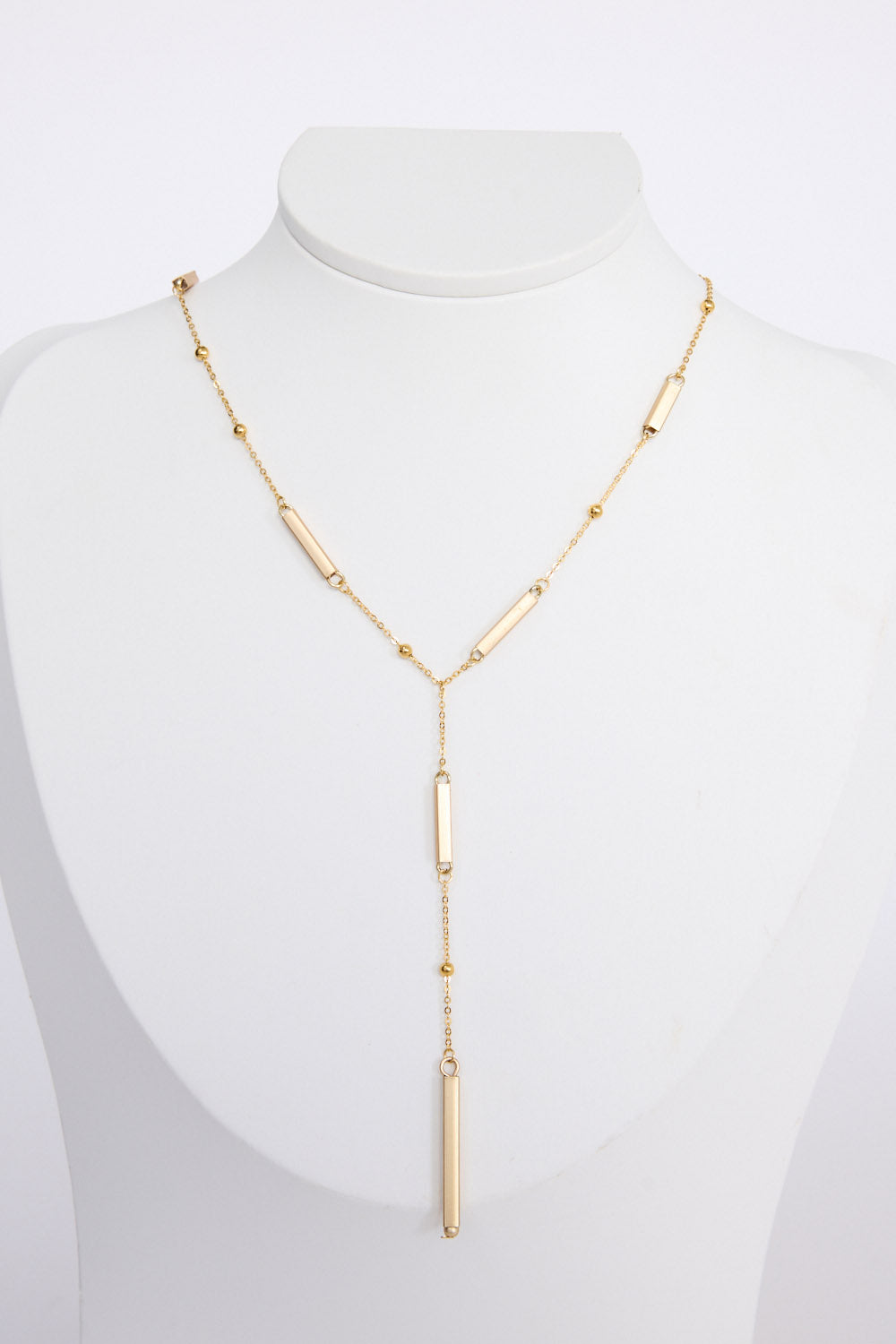 Bonita Necklace in gold with drop detailing, front view on white background