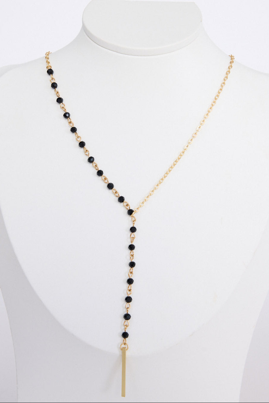 Isla Necklace in gold with drop detailing, angled view on white background