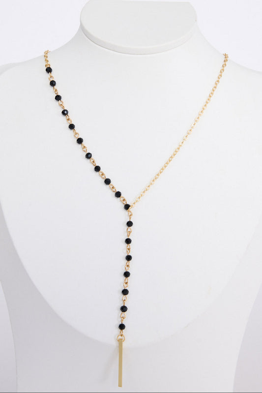 Isla Necklace in gold with drop detailing, angled view on white background