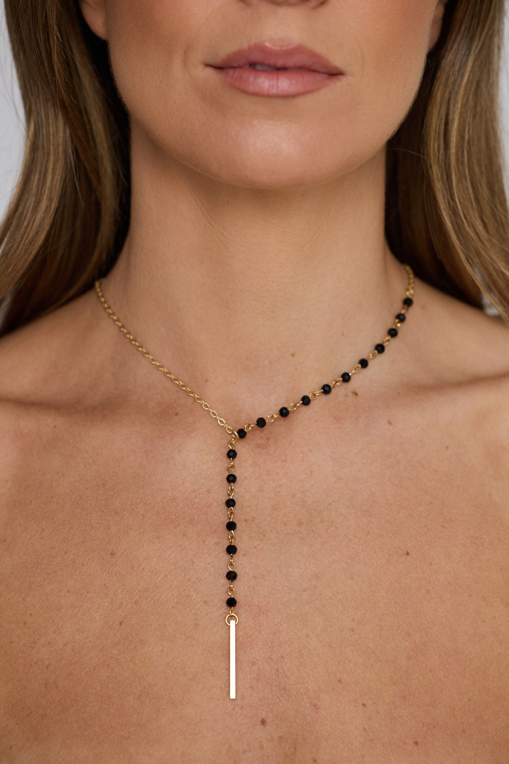 Isla Necklace in gold with drop detailing, front display view on neutral background