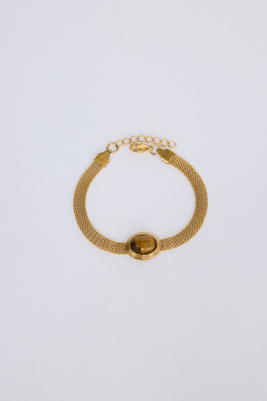 Dorris Bracelet in amber with a central oval stone detail, front view on white background
